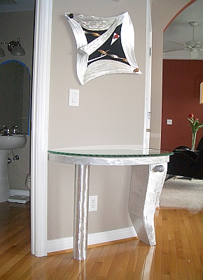 foyer table and art piece in aluminum