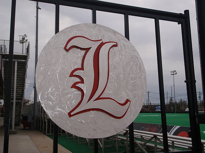 Uof L logo on gates and in aluminum and university of louisville L logo
