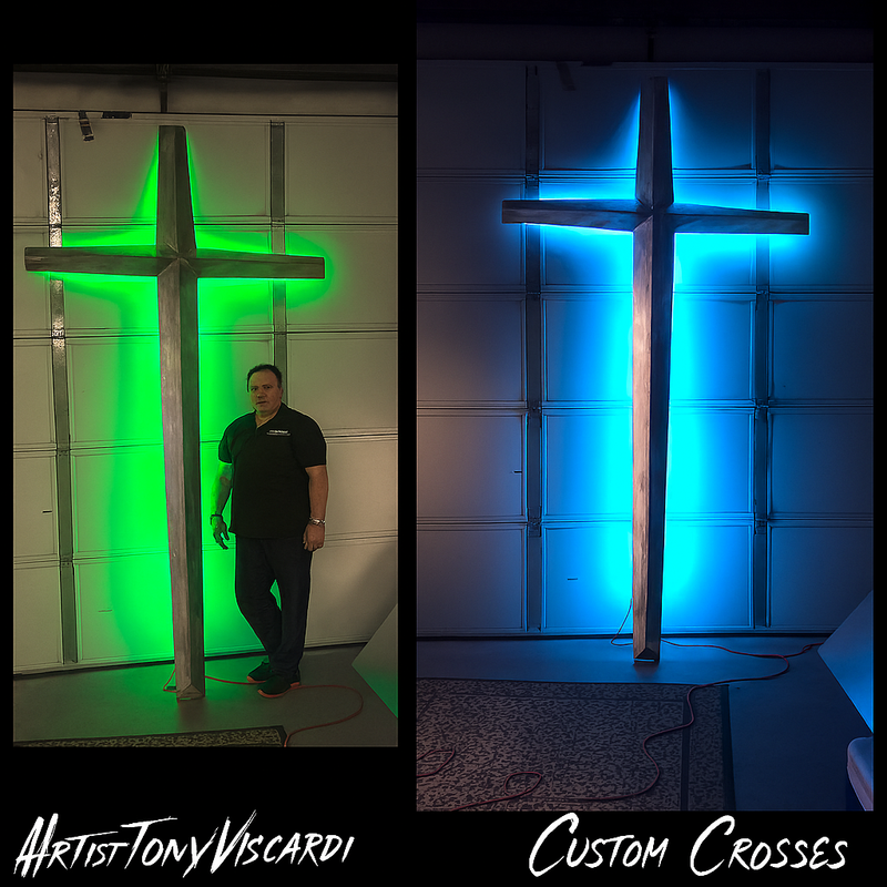 Monumental aluminum cross with color-changing lights  Large-scale lighted cross standing beside church