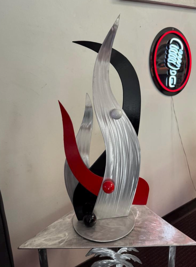 black and red tabletop sculpture in aluminum top